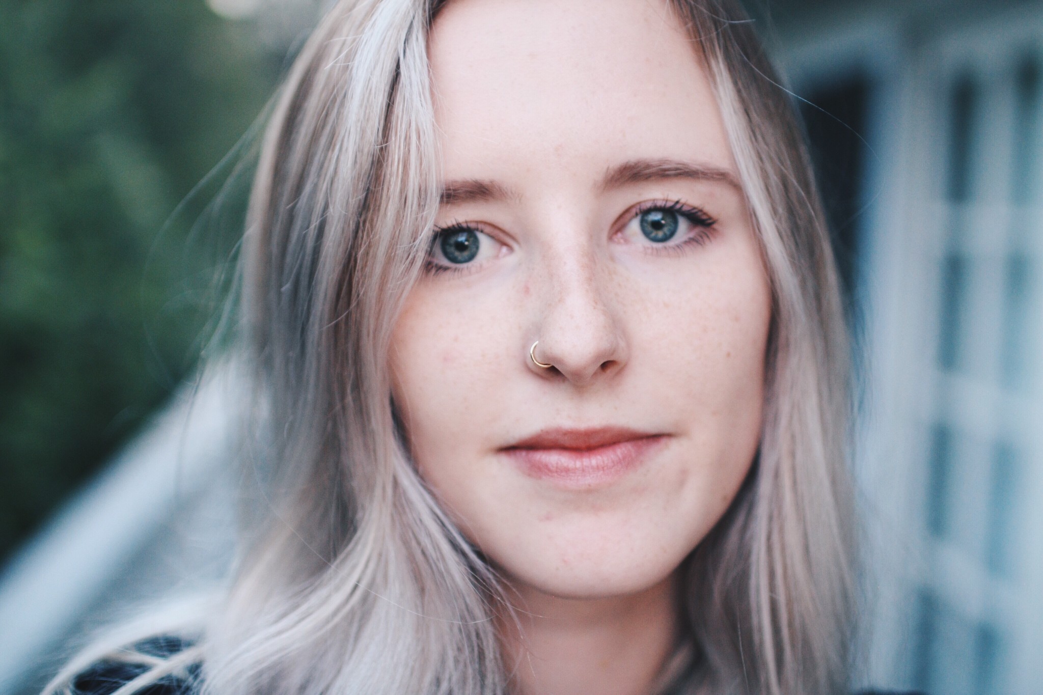 Close up of young person with nose ring