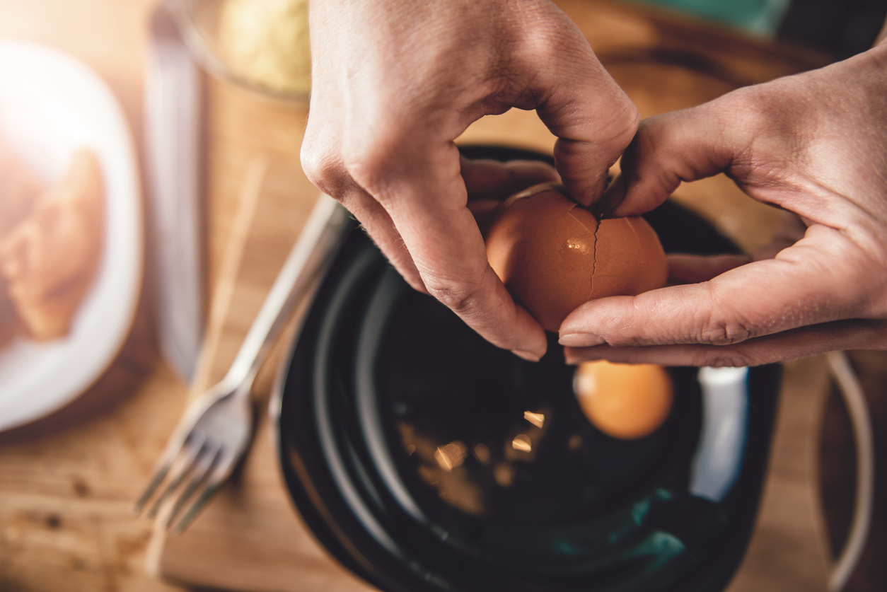 Cracking eggs into a bowl