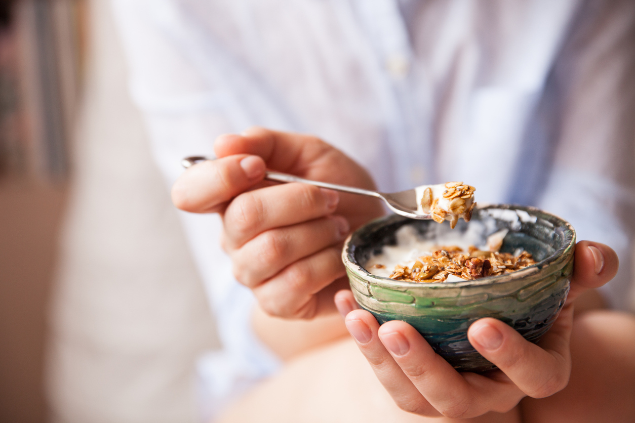 Eating museli from a small bowl