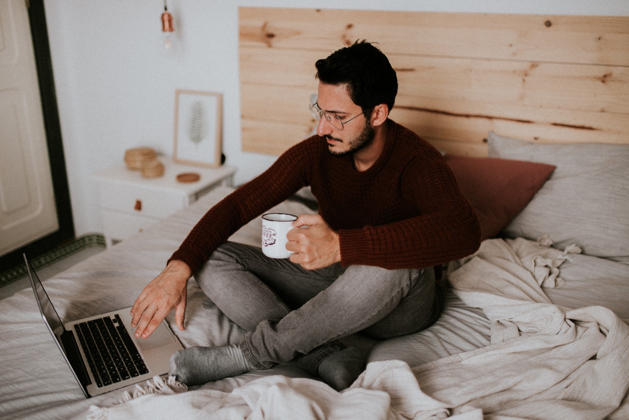 Young man on a laptop in bed