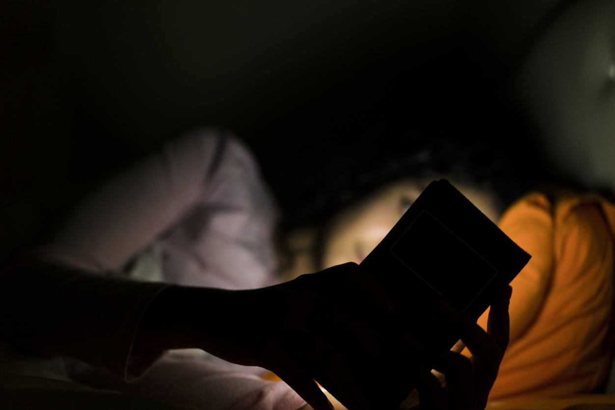 On phone in bed