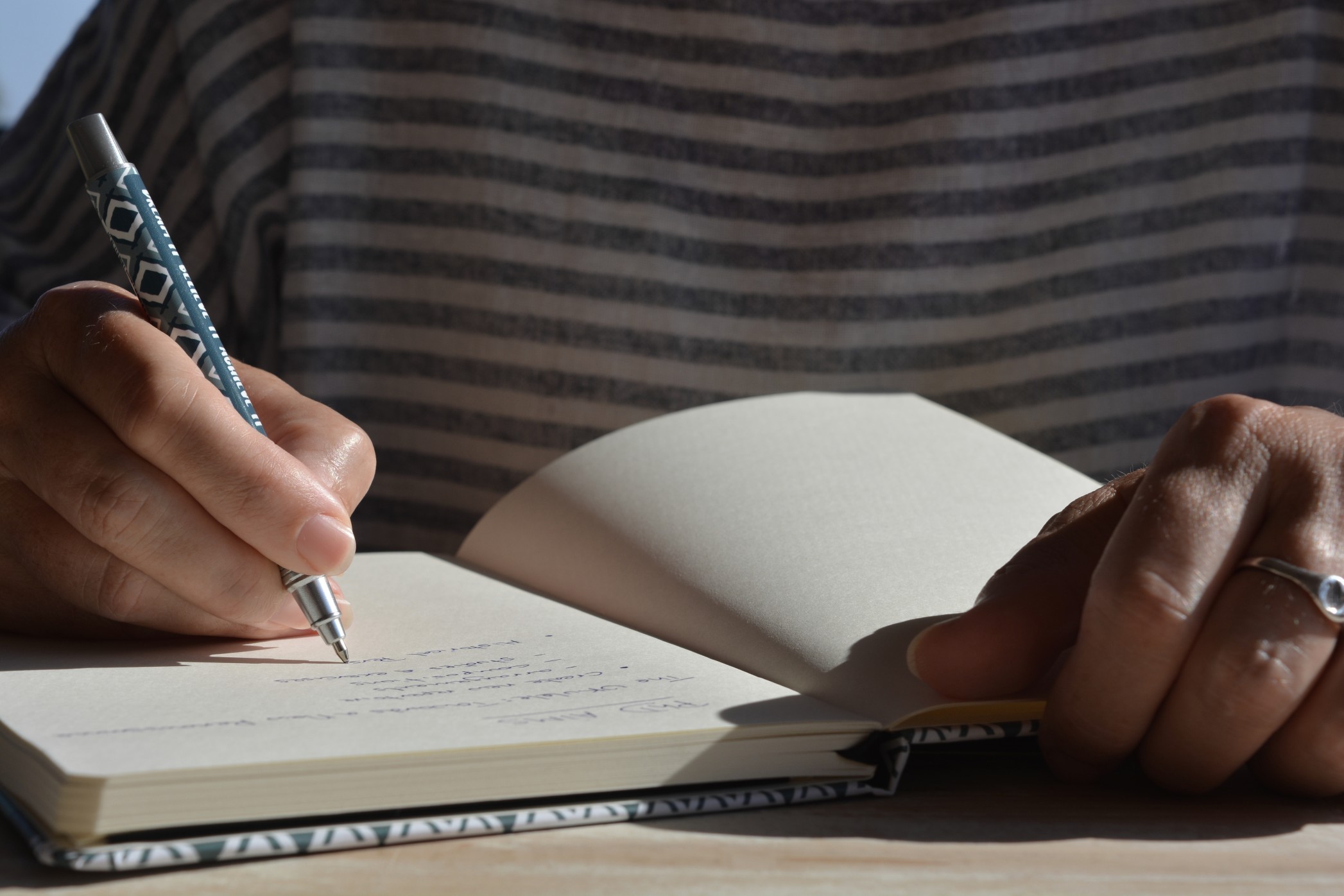 Woman writing in a journal mid section low angle view t20 gok A Kb
